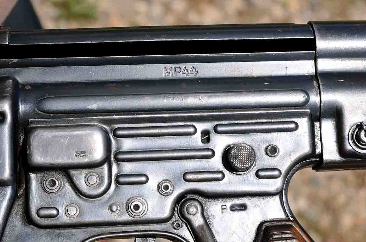 The large round button on the left side of the MP44 is for semi-auto or full-auto. Pushed to the left as in the photo it is set for full-auto.